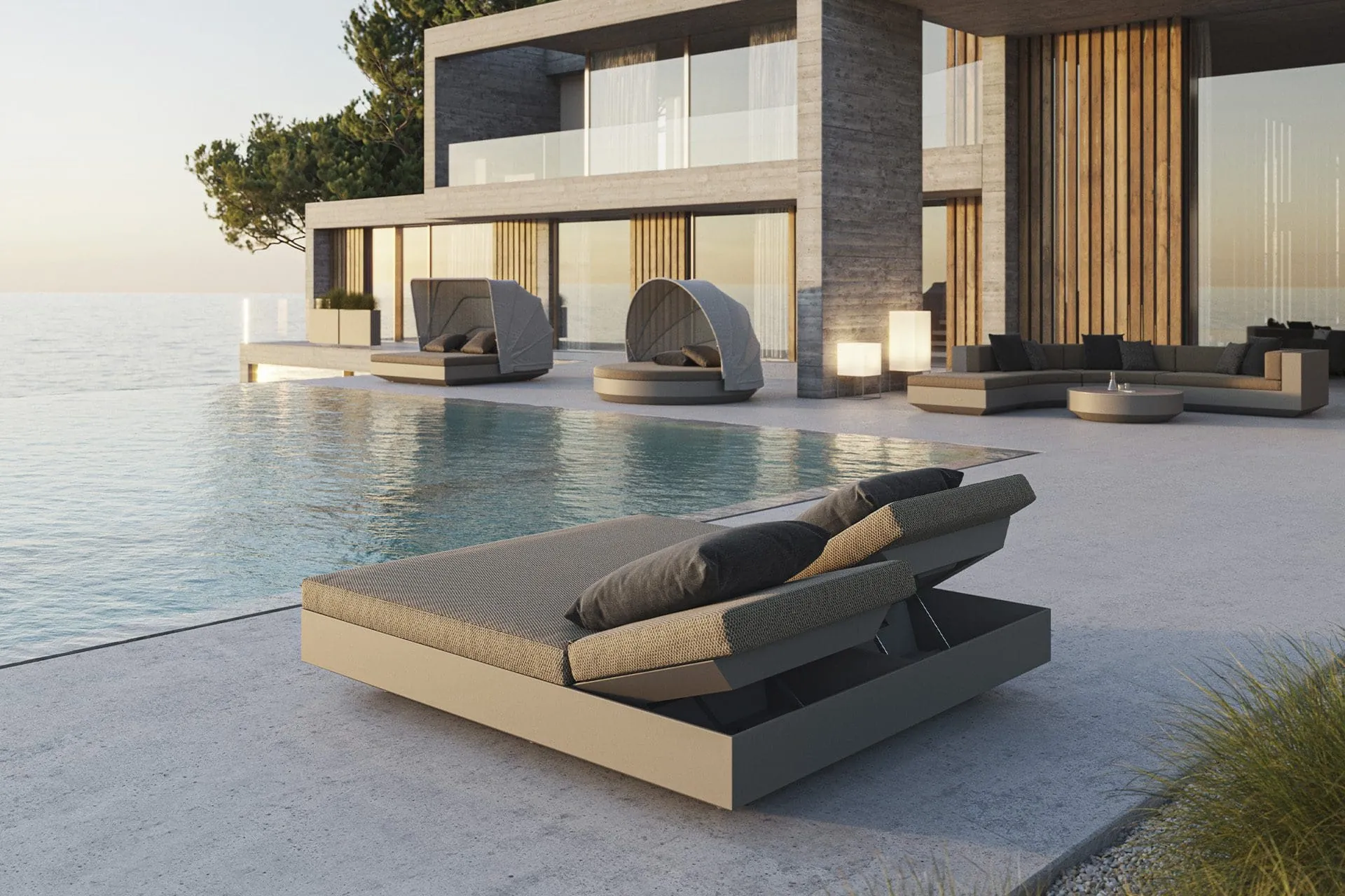 Terraza junto a la piscina con camas Vela