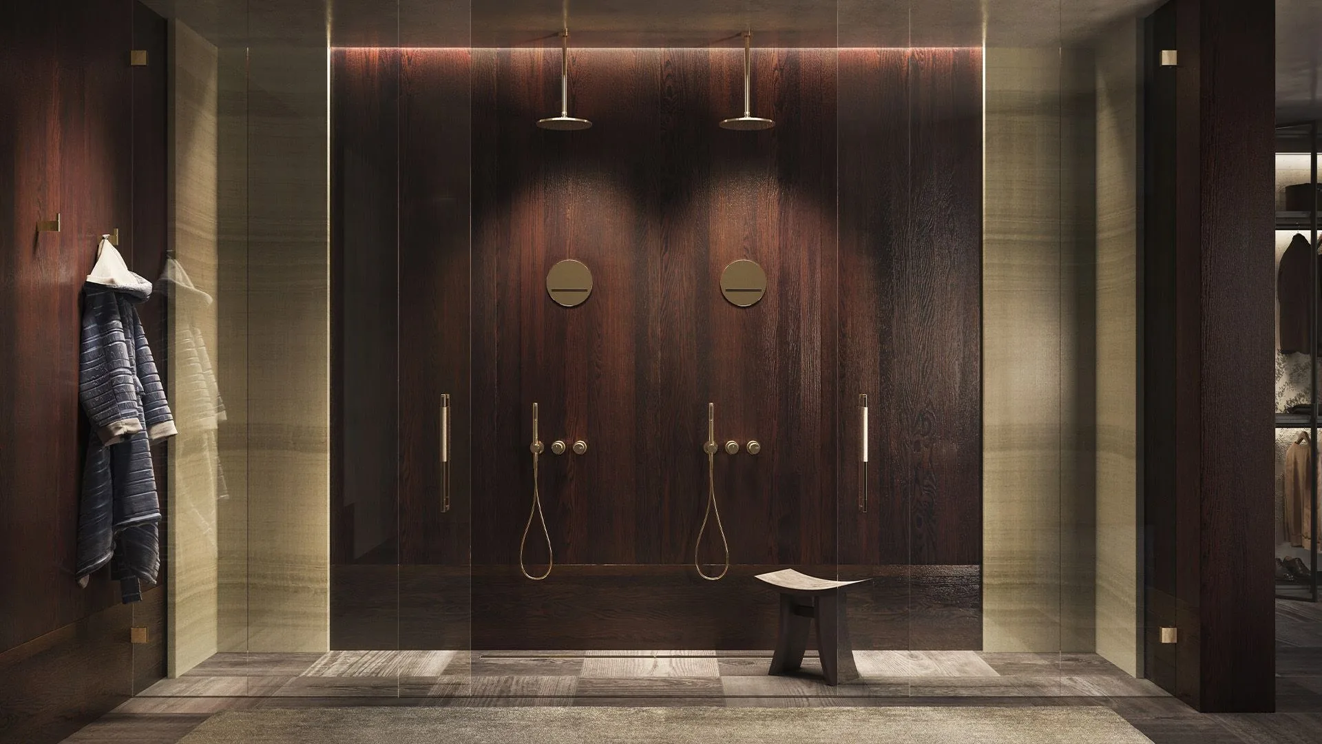 Double shower in a brass finish against dark wood